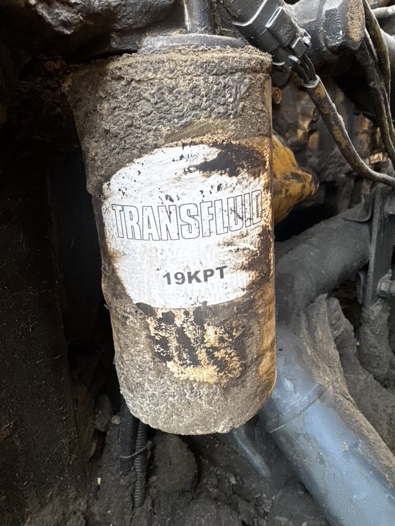 Transmission fluid filter caked in grime, label barely readable